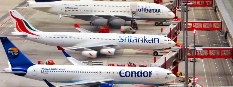 Airplanes from Condor, Sri Lankan, and Lufthansa airlines on the tarmac